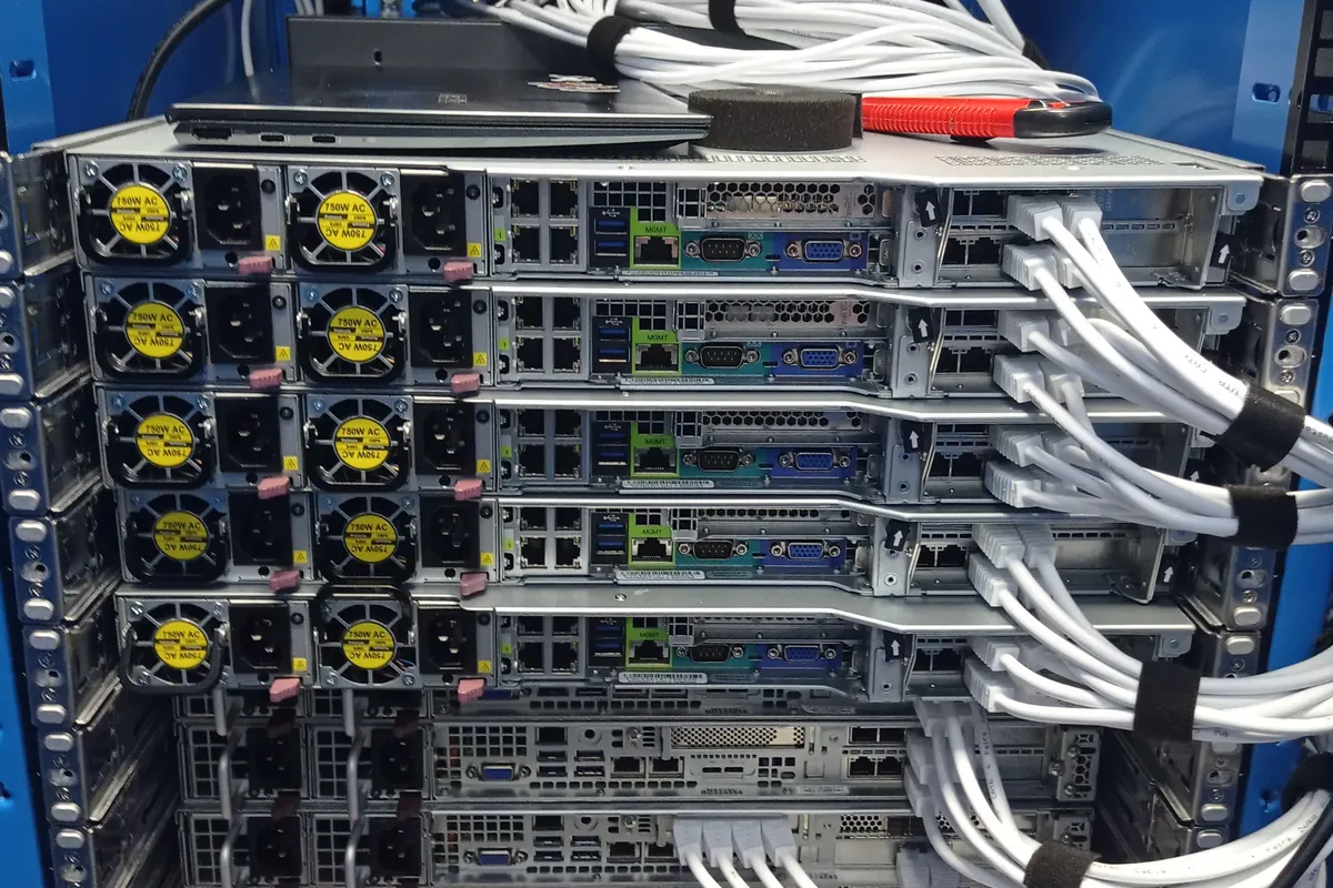 Server hardware with power and data cabling in a blue rack
